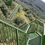 The metal stairs safely guide you over the steep rock walls