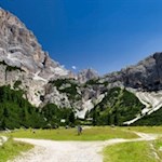 At the edge of a cozy alpine meadow, the rifugio Scotoni mountain hut invites you to stop for a break