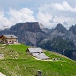 Die-Steviahütte-wird-von-mächtigen-Felsen-und-saftigen-Wiesen-umrahmt