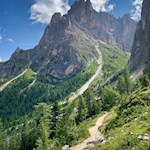 The path gently winds through the enchanting landscape at the foot of Sassolungo