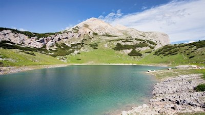 The shimmering lago di Limo lake with Col Bechei in the background